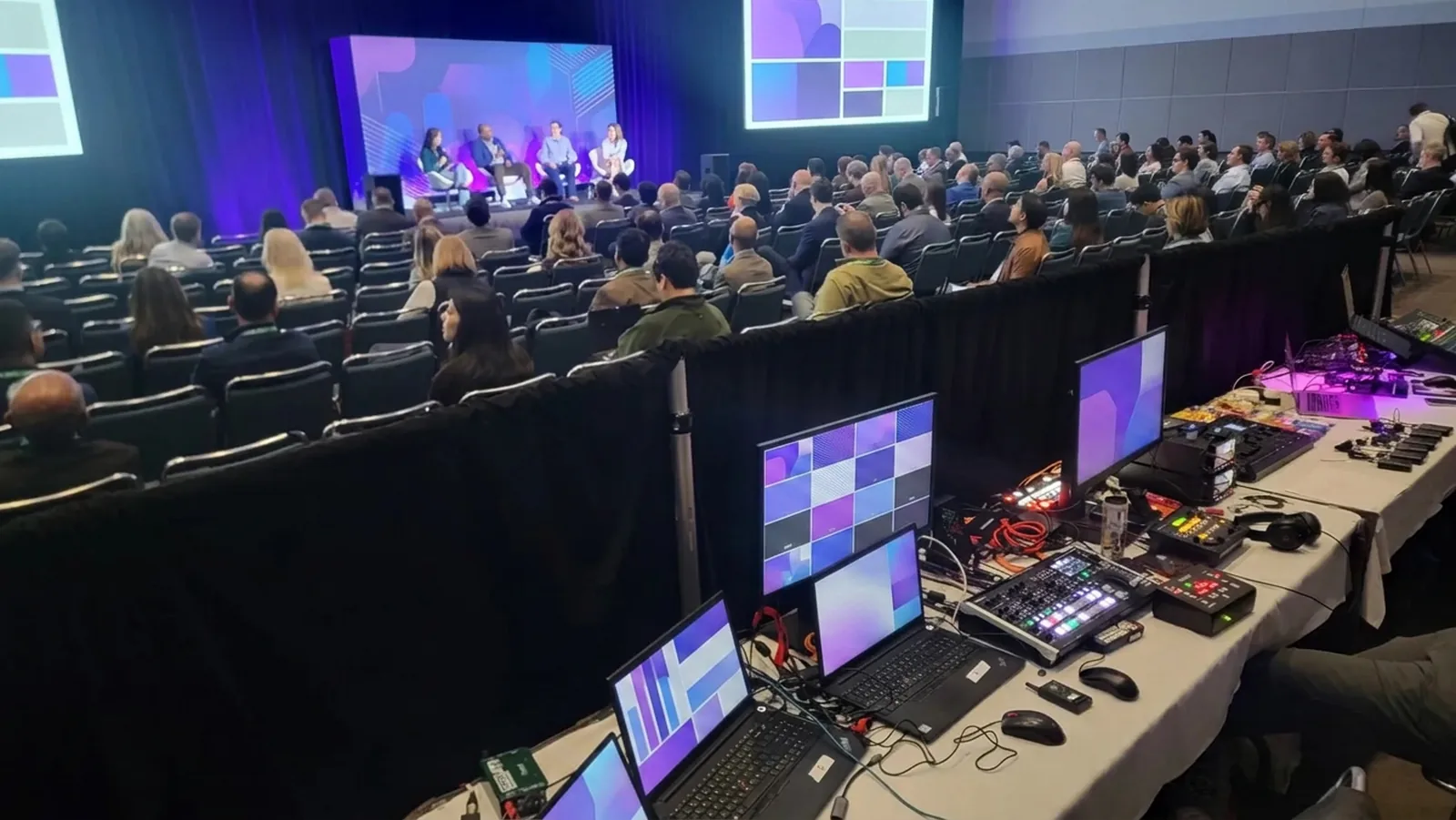 Show control desk supporting an executive presentation with dual screens and confidence monitoring